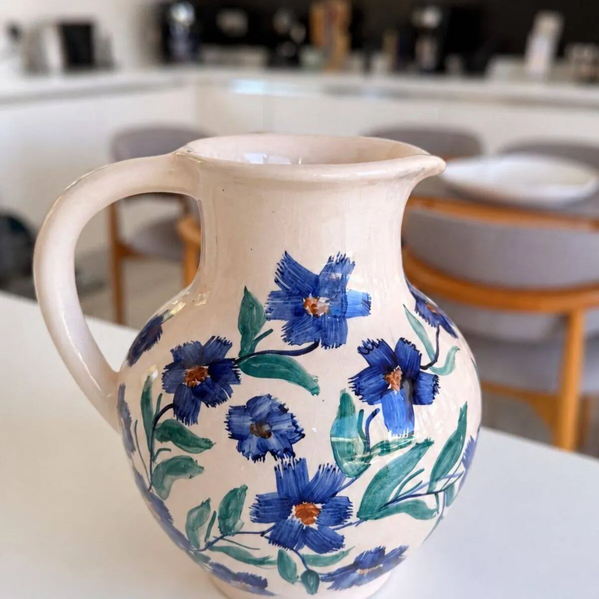 Handmade cream ceramic jug with hand-painted blue flowers and green leaves by Dizayn74