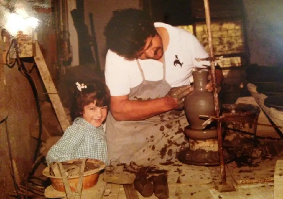 Hasan Eminağa at the wheel with one of his young daughters beside him in the studio
